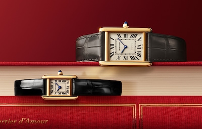Cartier Valentines campaign with Mens & Ladies Tank watches on red covered books image